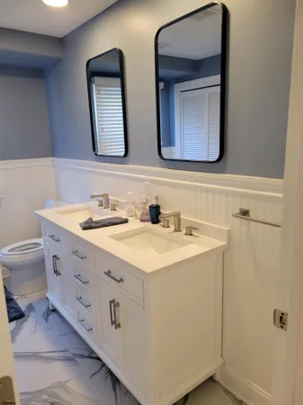 a bathroom with a double vanity sink and a mirror
