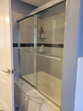 a bathroom with a glass shower door