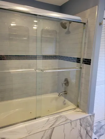 a bathroom with a bathtub and a shower