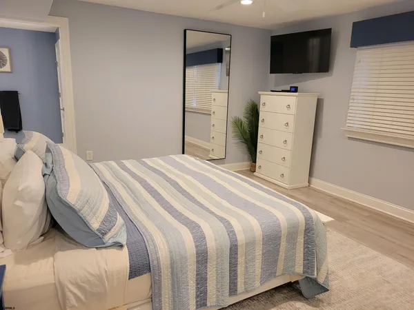 a bedroom with a bed and a flat screen tv