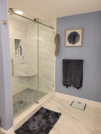 a bathroom with a shower and a sink