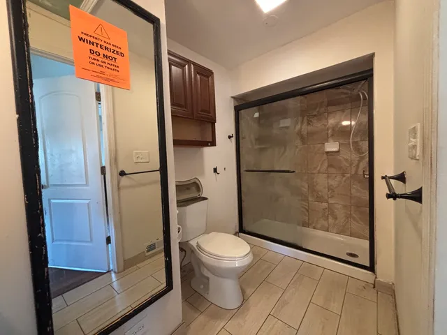 a bathroom with a shower and a toilet