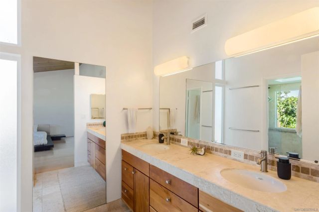 a bathroom with a sink double vanity and a shower