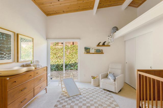 a spacious bedroom with a bed and a window