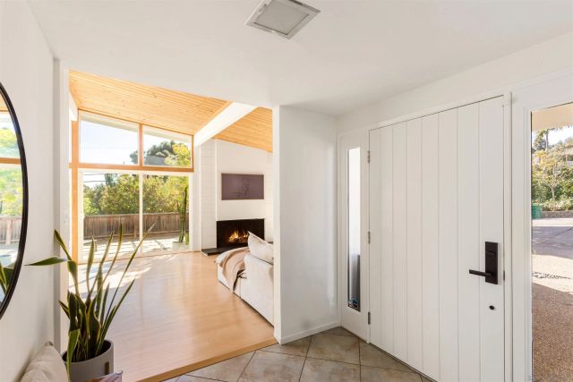 a living room with furniture large windows and a flat screen tv