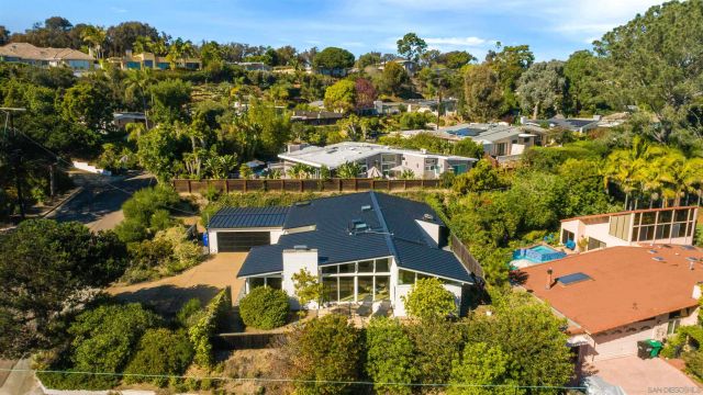 an aerial view of a house with a yard basket ball court and outdoor seating