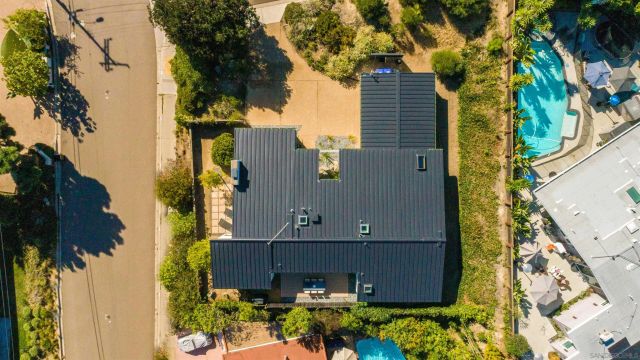 an aerial view of a house with a yard and potted plants