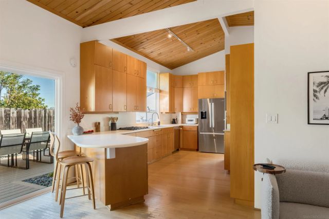 a kitchen with a sink a counter top space and stainless steel appliances