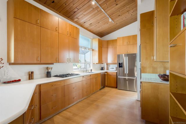 a kitchen with a sink appliances and cabinets