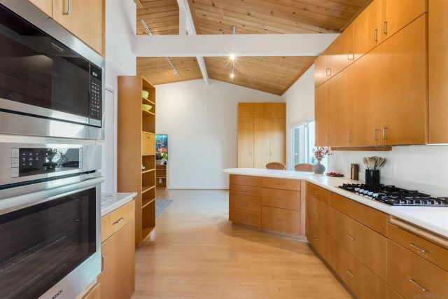a kitchen with stainless steel appliances a sink stove and refrigerator