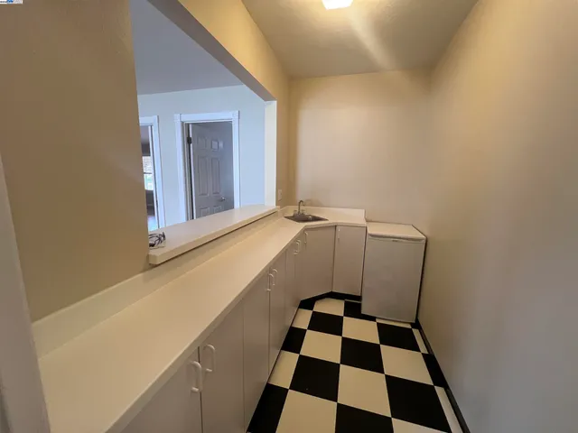 a view of a storage & utility room with a sink