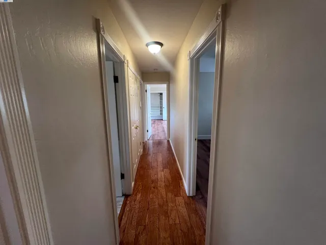 a view of hallway with wooden floor