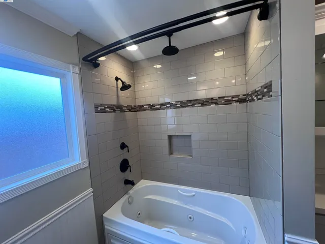 a bathroom with a tub and shower