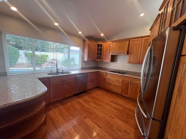 a kitchen with stainless steel appliances sink a microwave and cabinets