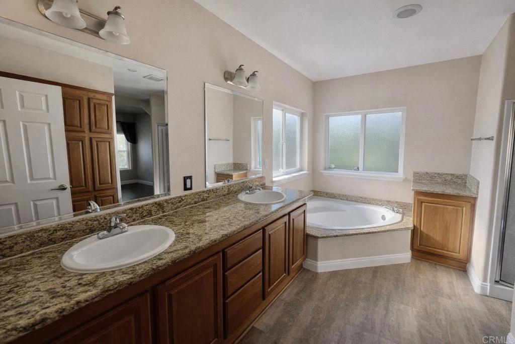 441 Rancho Santa Fe Road Encinitas, CA 92024 - Photo 13 of 17 a bathroom with a granite countertop double vanity sink and a mirror