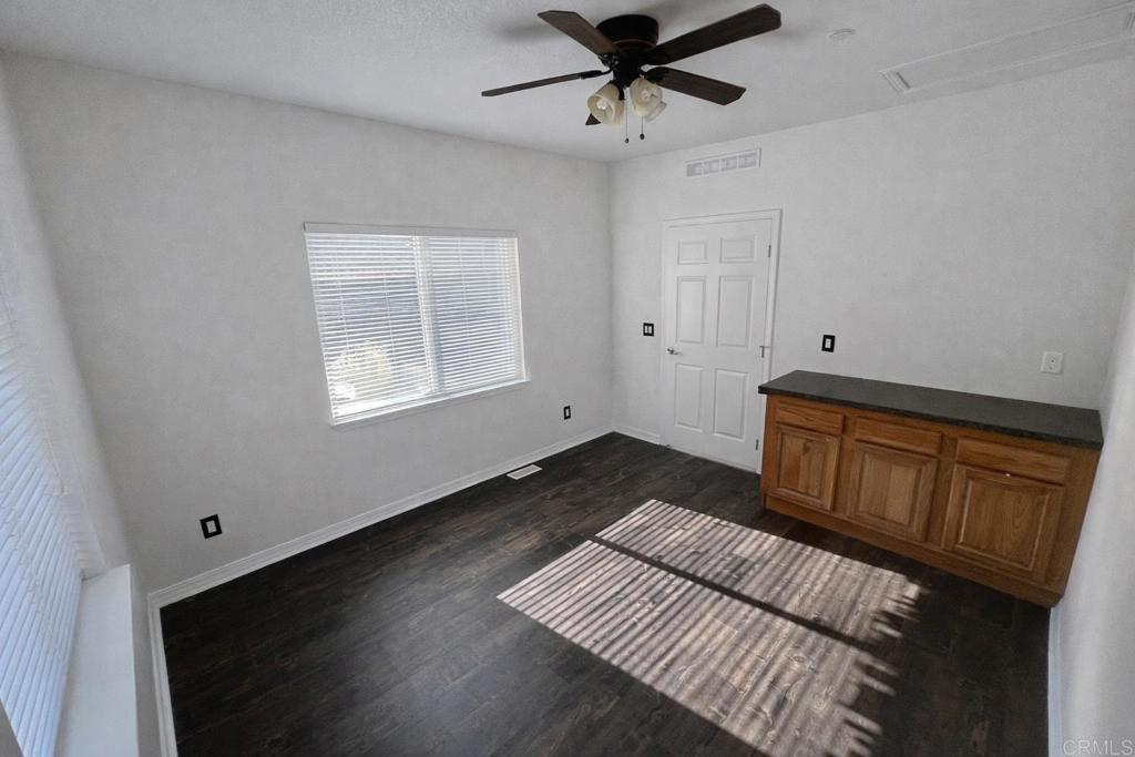441 Rancho Santa Fe Road Encinitas, CA 92024 - Photo 16 of 17 a view of an empty room with a window and wooden floor