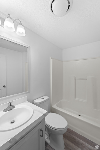 2600 North Hill Field Road, Unit 103A Layton, UT 84041 - Photo 22 of 31 Full bathroom featuring a white vanity with an undermount sink, a toilet, and a white tub/shower combination