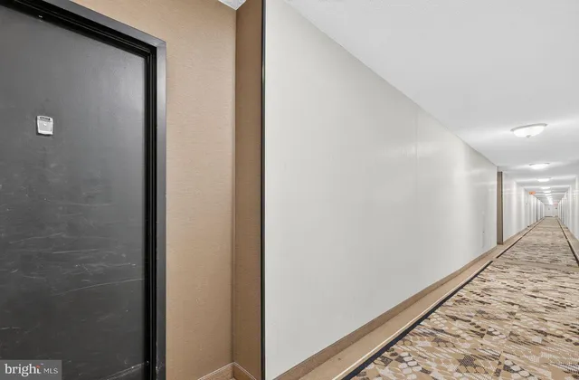 a view of hallway with wooden floor