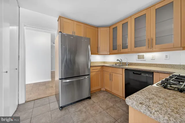 a kitchen with a refrigerator sink and stove