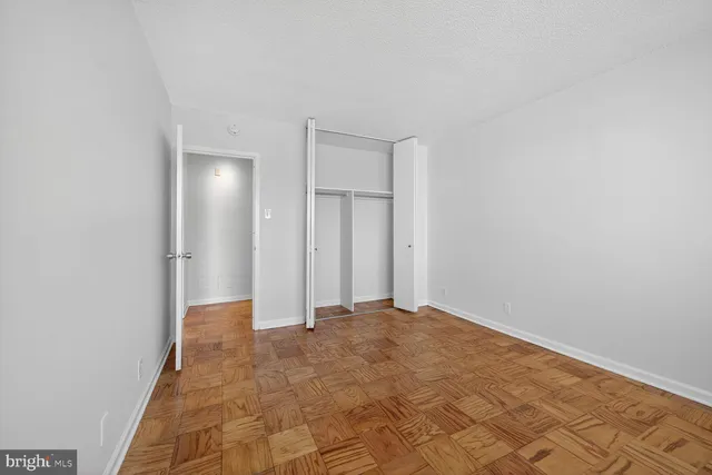 a view of a big room with window and cabinet
