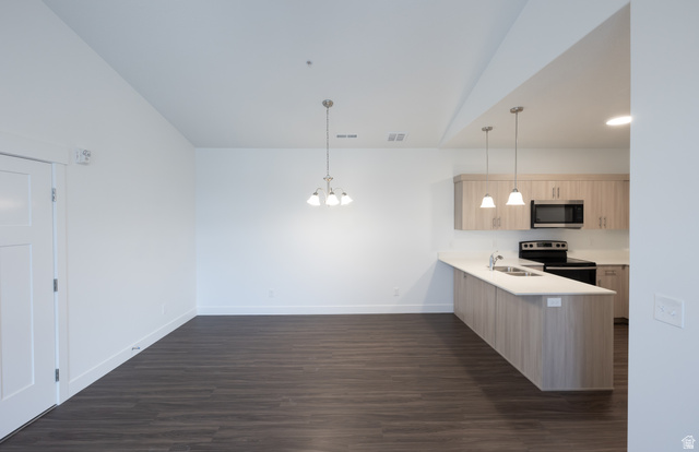 4653 South Alder Drive, Unit H302 Mapleton, UT 84664 - Photo 4 of 15 Kitchen with light wood finish cabinets, stainless steel appliances, a peninsula, a chandelier, and dark wood-type flooring