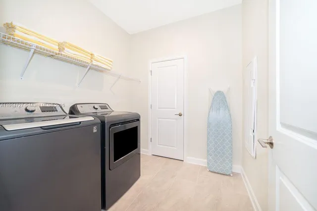a view of a swimming pool with a table and chairs under an umbrella