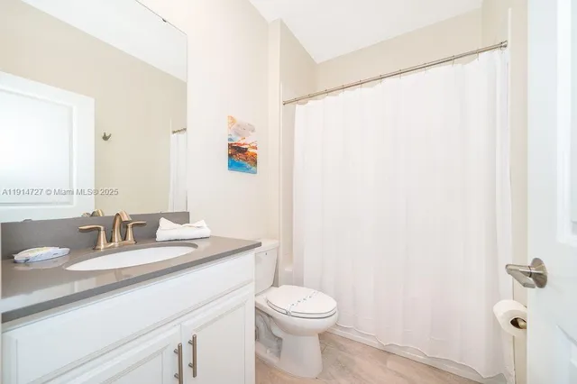 a view of a swimming pool with a lawn chairs and palm tree