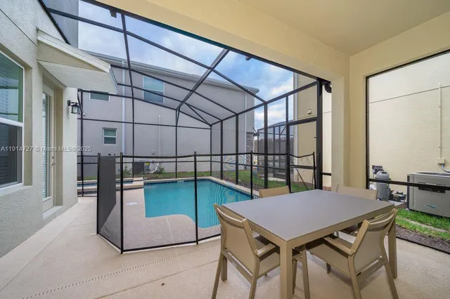 a view of a dining table chairs and table in the room
