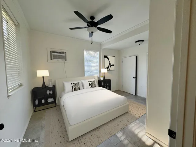 a bedroom with a bed and a ceiling fan