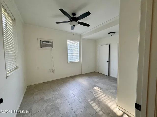a view of a livingroom with a ceiling fan and window