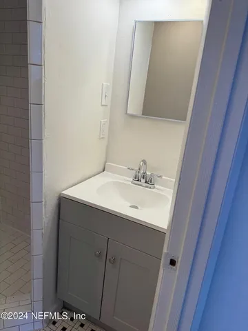 a bathroom with a sink and mirror