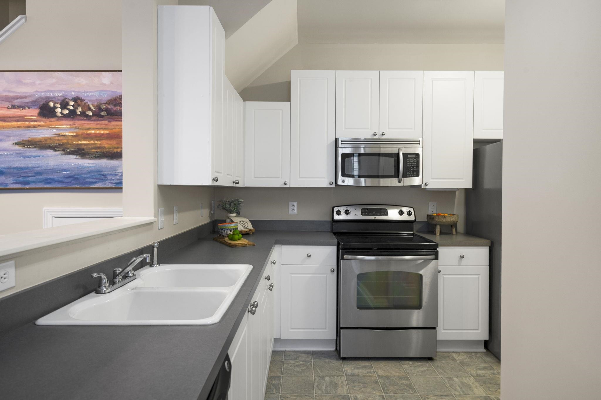 2312 Persimmon Ridge Drive Raleigh, NC 27604 - Photo 14 of 34 a kitchen with a sink stove and microwave