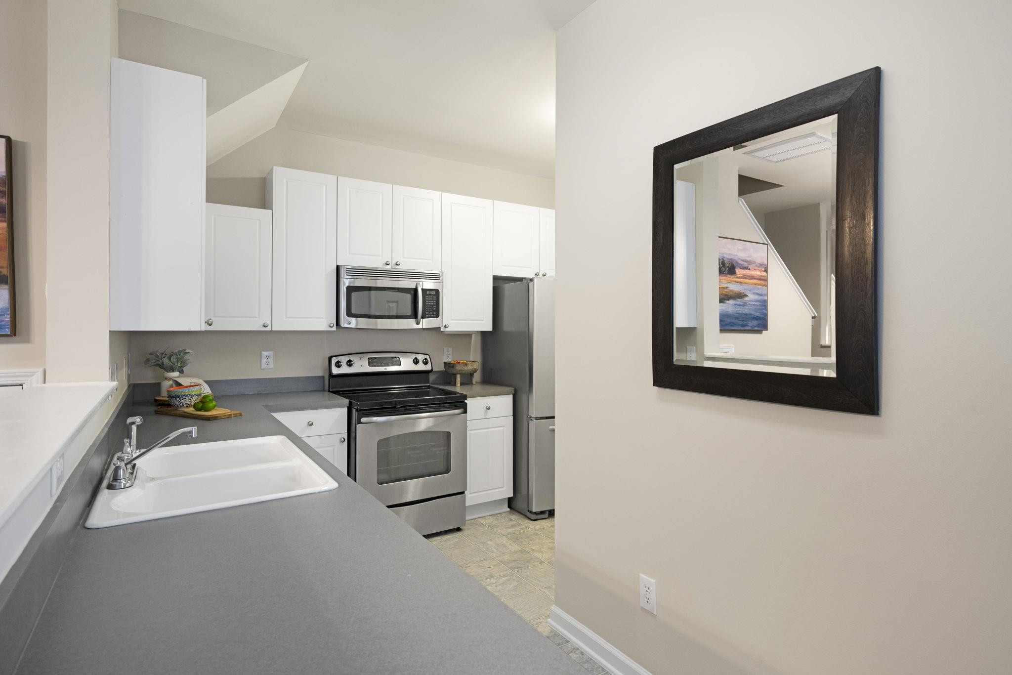 2312 Persimmon Ridge Drive Raleigh, NC 27604 - Photo 15 of 34 a kitchen with a refrigerator and a stove top oven