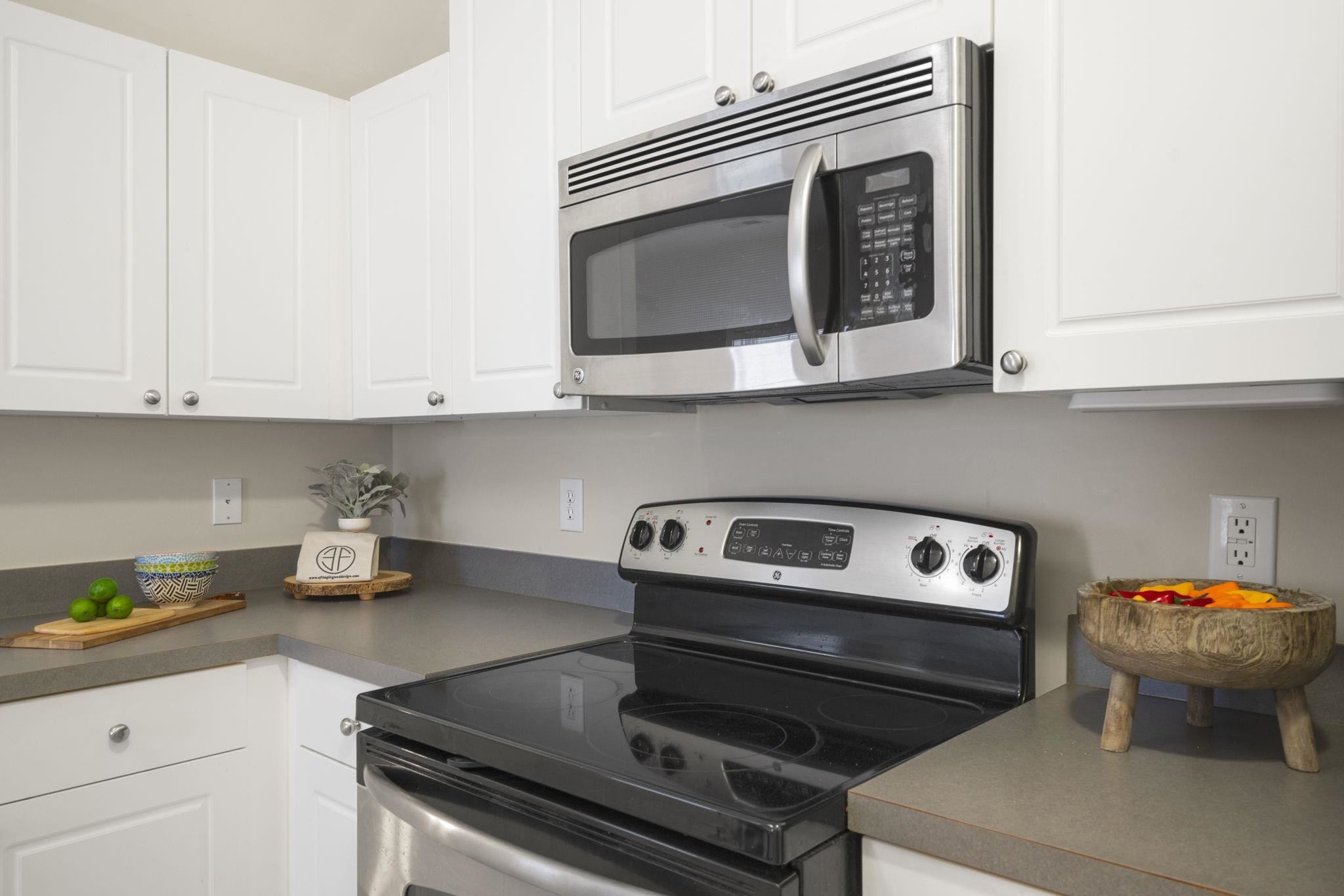 2312 Persimmon Ridge Drive Raleigh, NC 27604 - Photo 17 of 34 a kitchen with a stove and a microwave