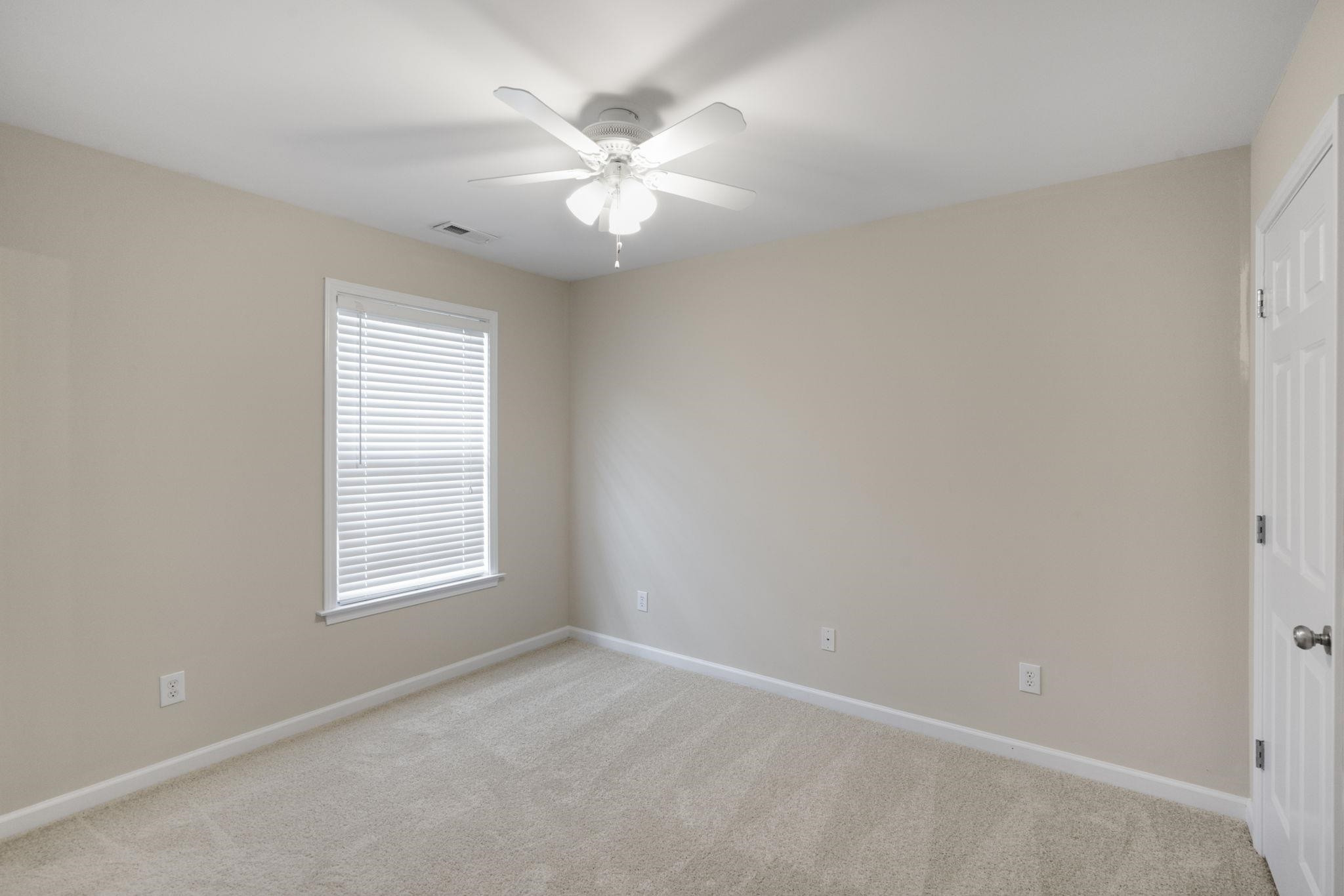 2312 Persimmon Ridge Drive Raleigh, NC 27604 - Photo 25 of 34 an empty room with windows and fan