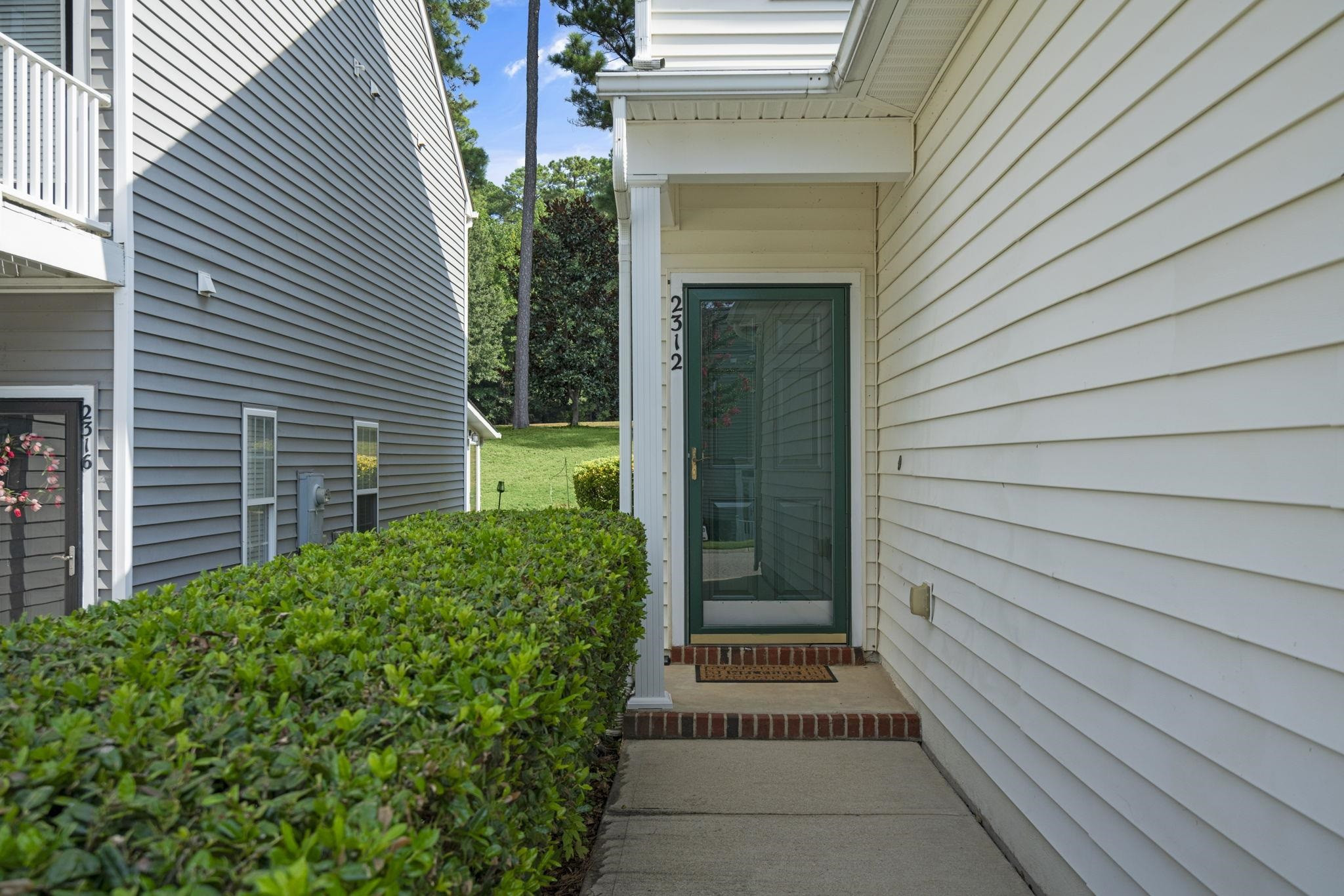 2312 Persimmon Ridge Drive Raleigh, NC 27604 - Photo 4 of 34 a view of a pathway besides a house