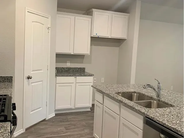 a kitchen with a sink and cabinets