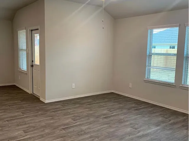 a view of an empty room and wooden floor