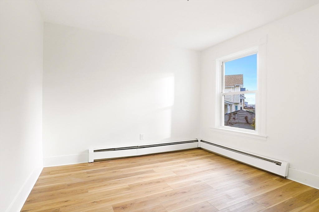 12 Temple Street Holyoke, MA 01040 - Photo 11 of 36 a view of an empty room with wooden floor and a window