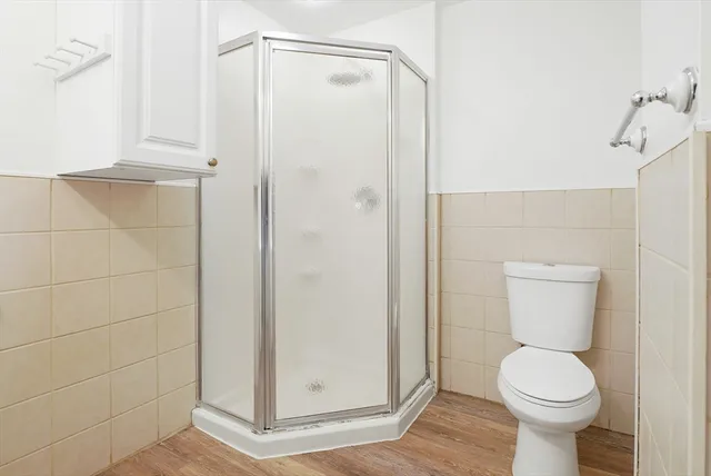 a bathroom with a toilet and a shower