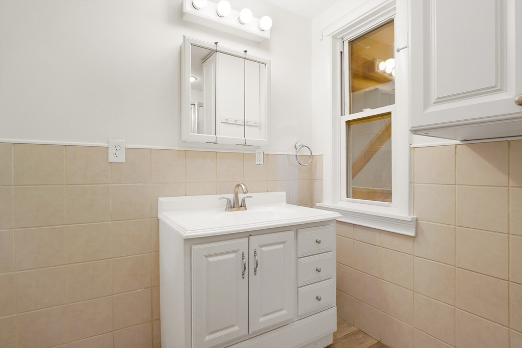 12 Temple Street Holyoke, MA 01040 - Photo 14 of 36 a bathroom with a sink and a mirror