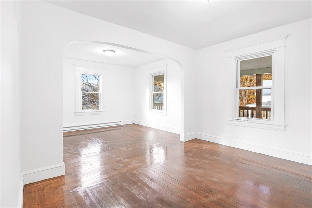 12 Temple Street Holyoke, MA 01040 - Photo 21 of 36 an empty room with wooden floor and windows