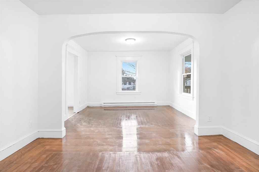 12 Temple Street Holyoke, MA 01040 - Photo 22 of 36 an empty room with wooden floor and windows