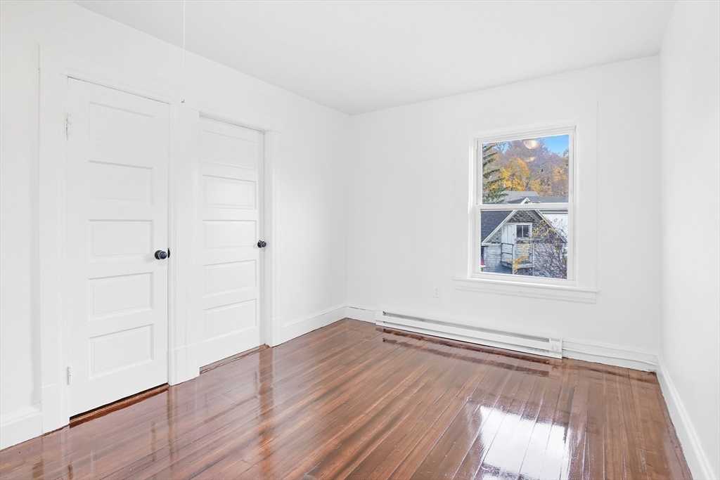 12 Temple Street Holyoke, MA 01040 - Photo 24 of 36 an empty room with wooden floor and windows