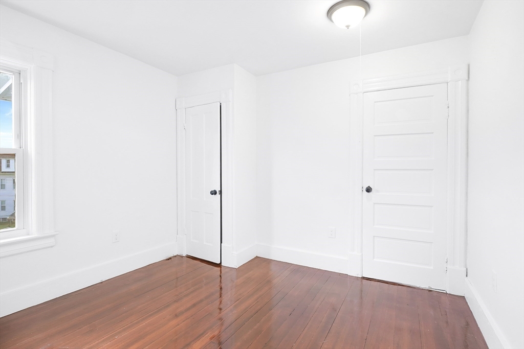 12 Temple Street Holyoke, MA 01040 - Photo 25 of 36 an empty room with a hardwood and wooden floor
