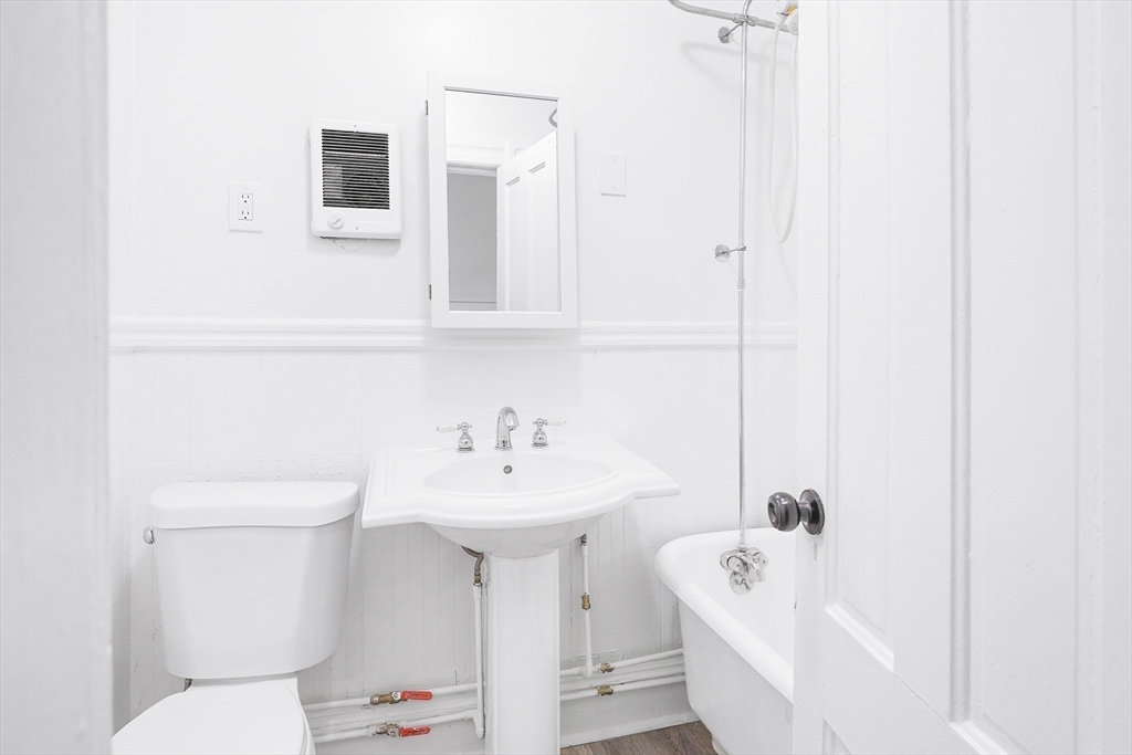 12 Temple Street Holyoke, MA 01040 - Photo 26 of 36 a bathroom with a sink a toilet and shower