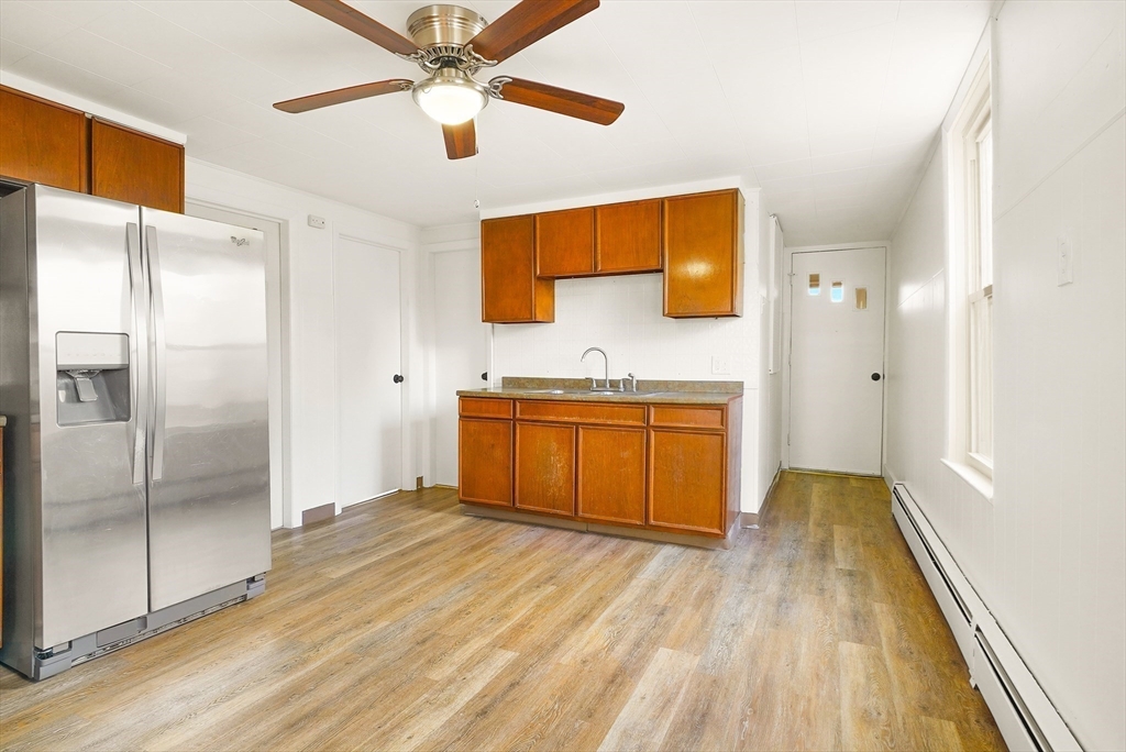 12 Temple Street Holyoke, MA 01040 - Photo 3 of 36 a kitchen with stainless steel appliances granite countertop a refrigerator a sink and a stove