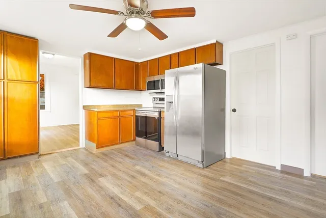 a kitchen with stainless steel appliances a refrigerator and a microwave
