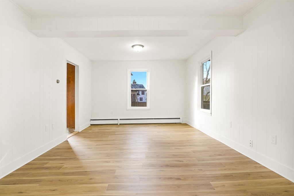 12 Temple Street Holyoke, MA 01040 - Photo 9 of 36 an empty room with wooden floor and windows
