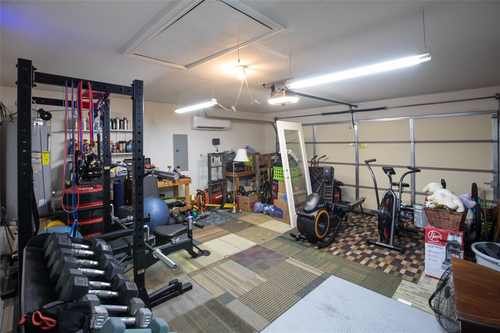 209 Timber Drive Princeton, TX 75407 - Photo 28 of 30 Garage has Epoxy flooring and a mini split/heat with insulated garage door. Great for a gym or other space.